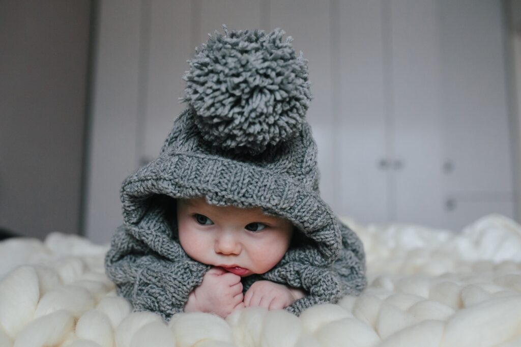 Small baby in knitted clothes